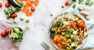 Zucchinis, lettuce, tomatoes, carrots, lemons, broccoli, rice, Brussels sprouts, ginger and herbs are all on the table. A healthy plant-based diet with little sugar in combination with dental care to prevent toothache.